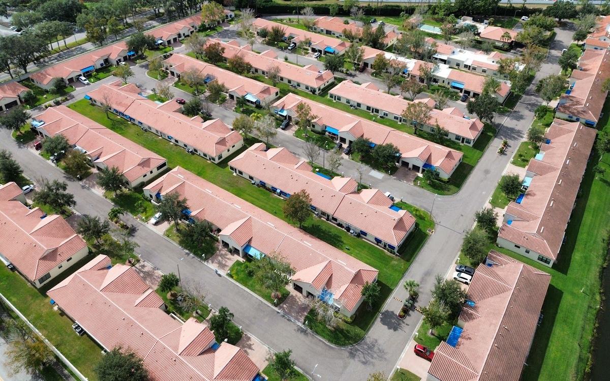 Drone aerial of an HOA community with 33 freshly soft washed tile roofs by Sandbar — real job photo