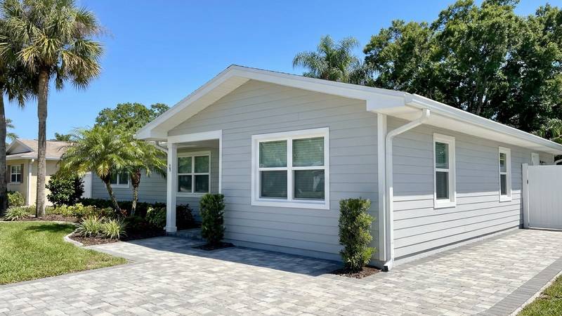 Example of house washing in Palm Harbor, FL — after soft washing. Hardie board - window frames, eaves, and downspouts detailed.