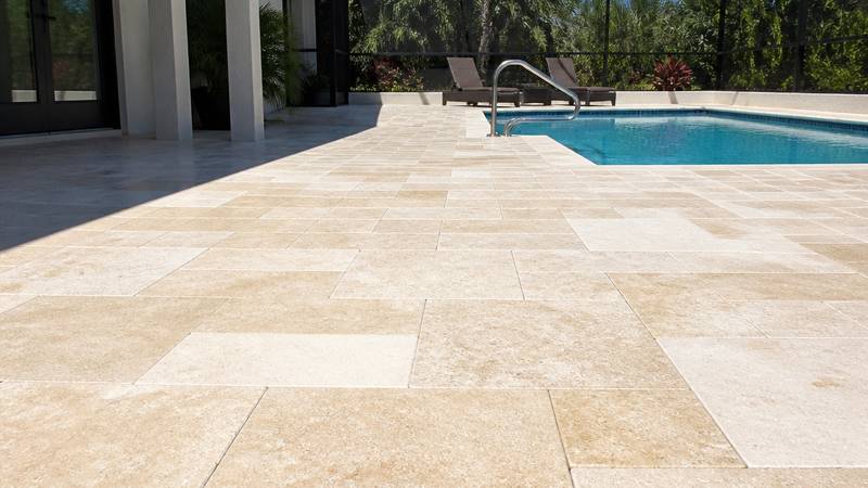 Example of patio & deck pressure washing in Safety Harbor, FL — after soft washing. Travertine pool deck - surface cleaner + rinse. No etching.