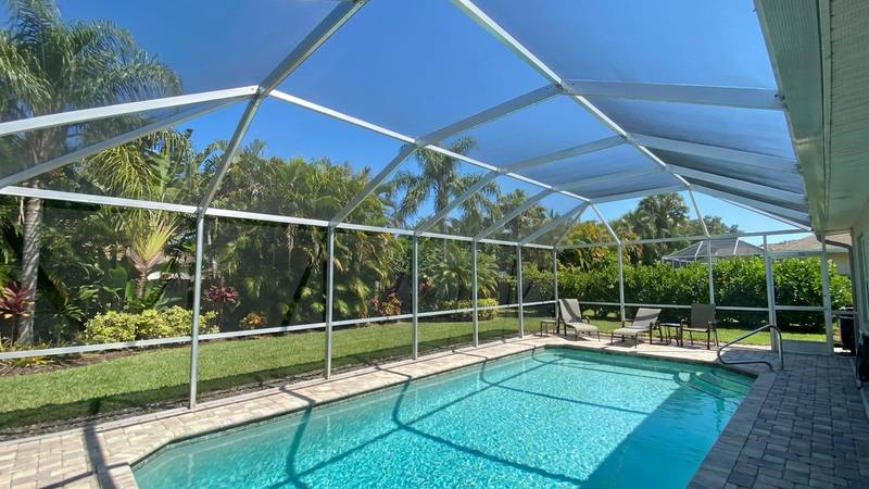 Example of pool cage cleaning in Palm Harbor, FL — after soft washing. Aluminum frame + screen panels - salt + mildew buildup from Gulf air.